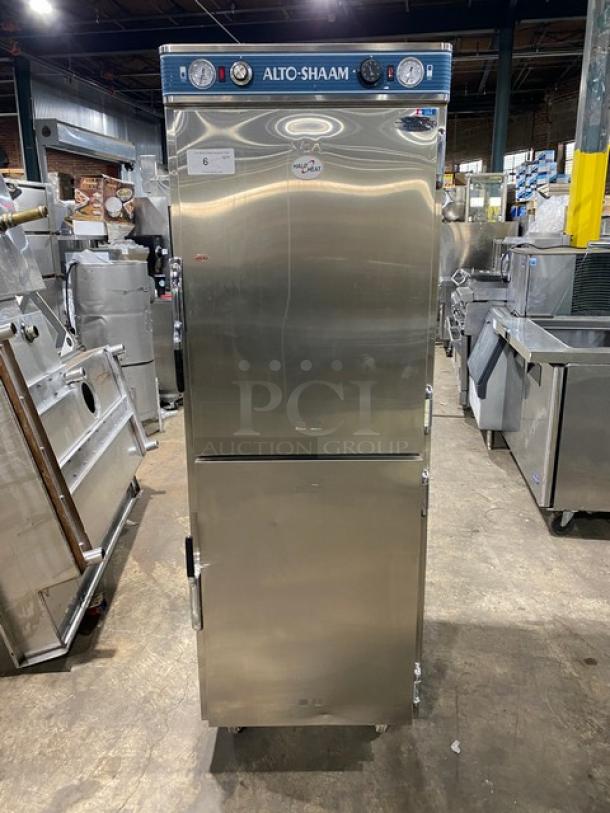 Alto-Shaam stainless steel dual-compartment heated cabinet, model 1200-UP/SR, with Dutch doors and controls. On casters.