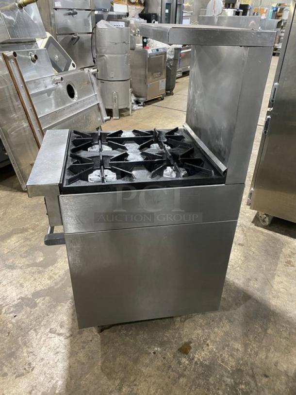 SunFire stainless steel 4-burner range/oven combo with backsplash, overhead salamander shelf, and wired oven rack on legs.