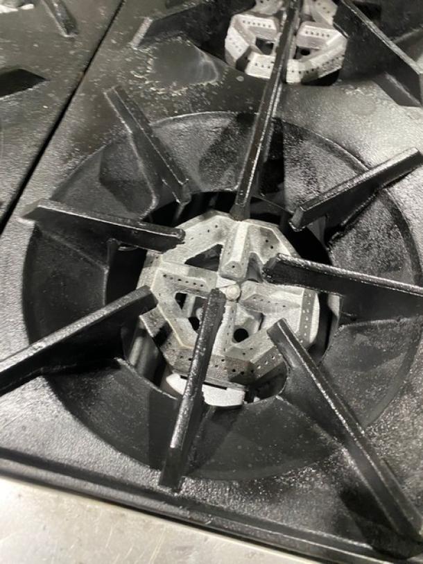 SunFire commercial stainless steel 4-burner range/oven, natural gas, with backsplash, overhead salamander shelf, on legs.