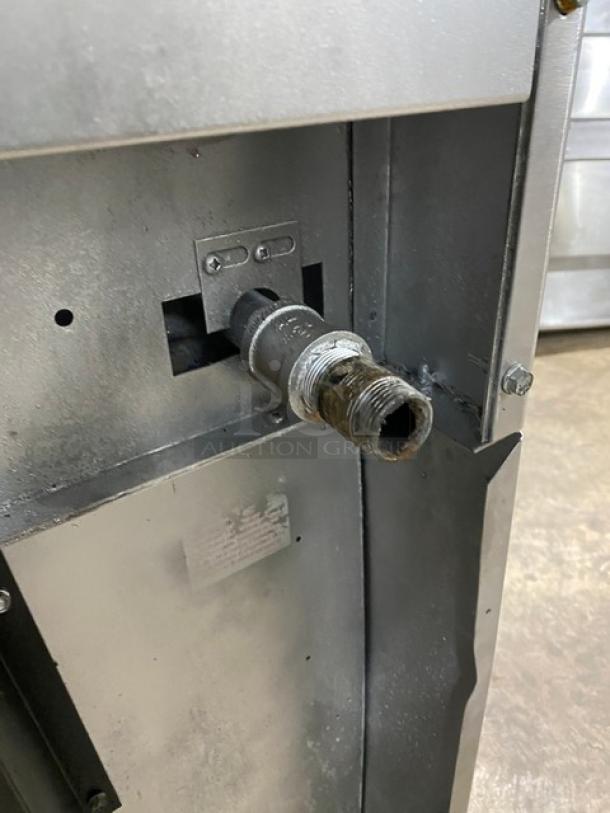 SunFire stainless steel gas-powered 4-burner range/oven combo, features include backsplash, overhead salamander shelf, and wired oven rack.