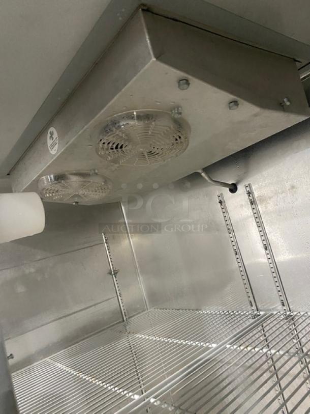 Continental 2F commercial stainless steel 2-door reach-in freezer interior. Features poly-coated wire rack, on casters.