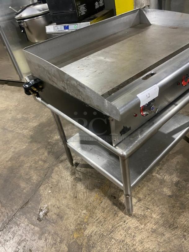 Star Commercial Stainless Steel Electric Griddle with back and side splash, single undershelf stand, on legs, used condition.
