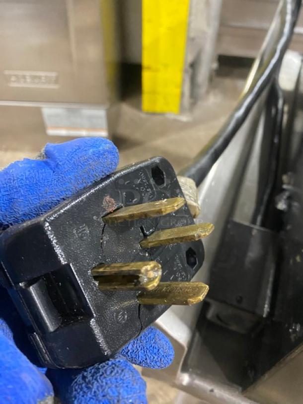 Cracked power plug of a Star Commercial Stainless Steel Electric Countertop Flat Griddle. Visible wear on plug.