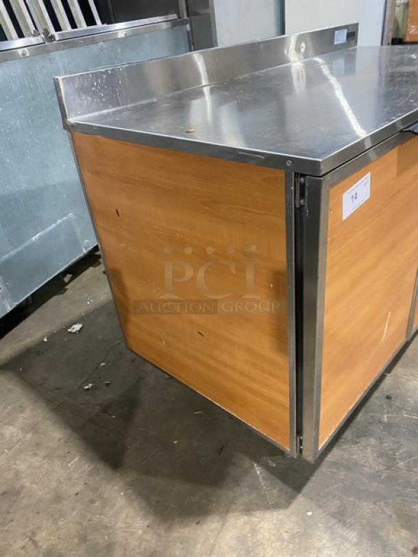 Duke Stainless Steel Wooden Style 2-Door Bar Back Refrigerator, Model RBC60M, with upturned backsplash, on legs, 120V.