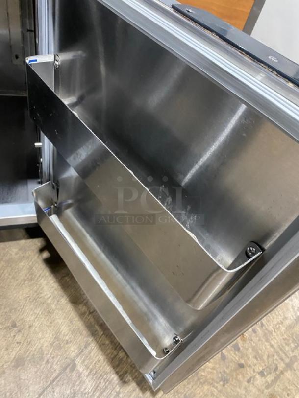 Duke RBC60M stainless steel refrigerator door interior with shelving, clean condition, suitable for bar use.