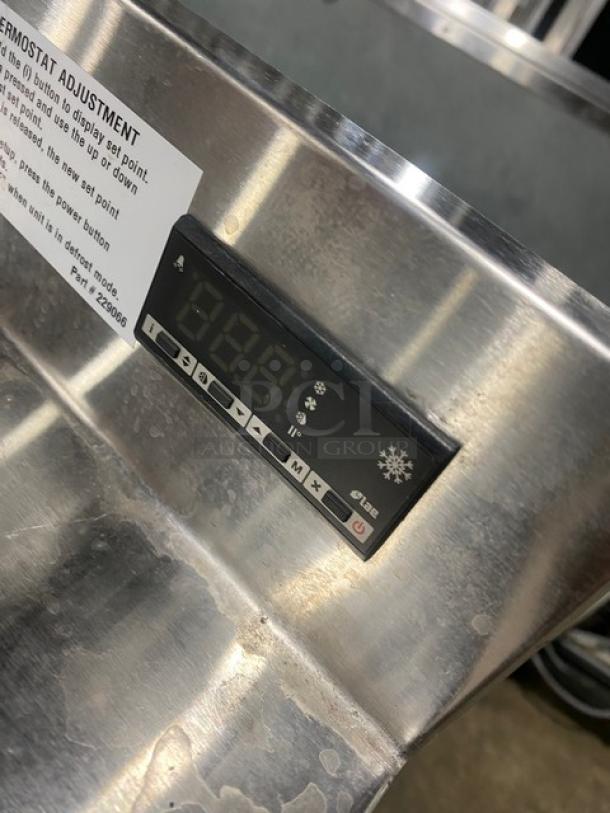 Duke RBC60M bar back refrigerator with digital control panel, stainless steel finish, and upturned backsplash.