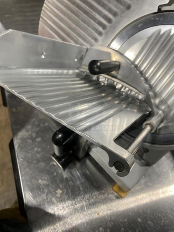 Commercial electric countertop deli meat slicer in good condition, featuring a stainless steel blade and adjustable thickness settings.