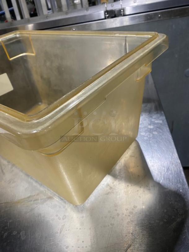 Amber food storage container, commercial-grade, durable plastic, slightly used, reinforced corners, ideal for bulk storage.