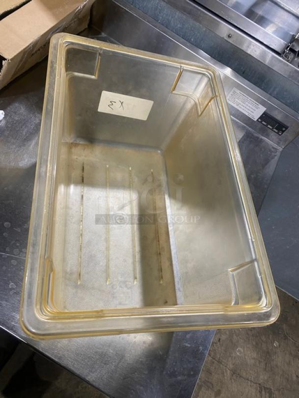 Commercial amber food storage container, rectangular, plastic, with a "3X" marking on side, used condition.