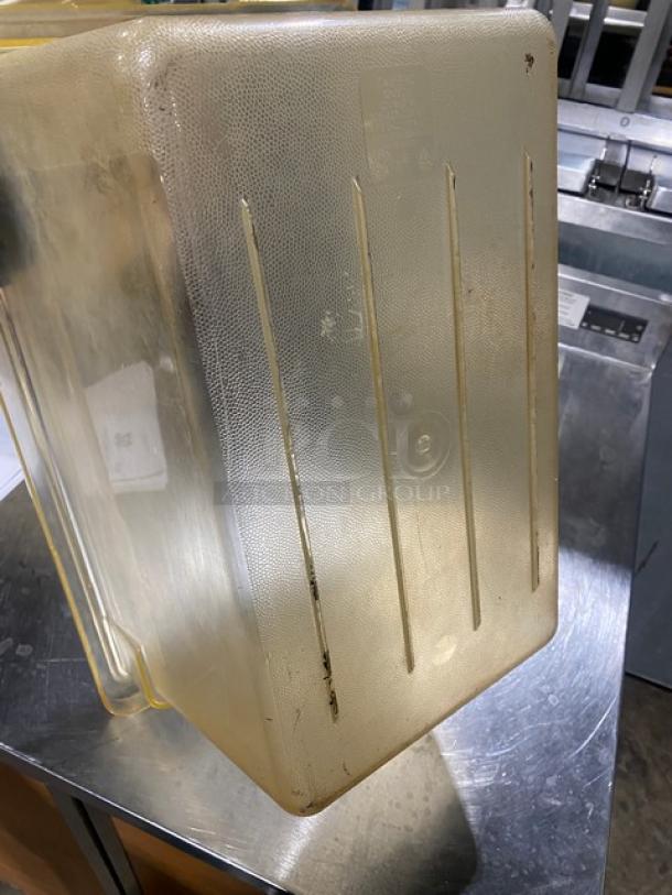 Commercial amber food storage container, textured surface, good condition with visible markings. Ideal for bulk storage.