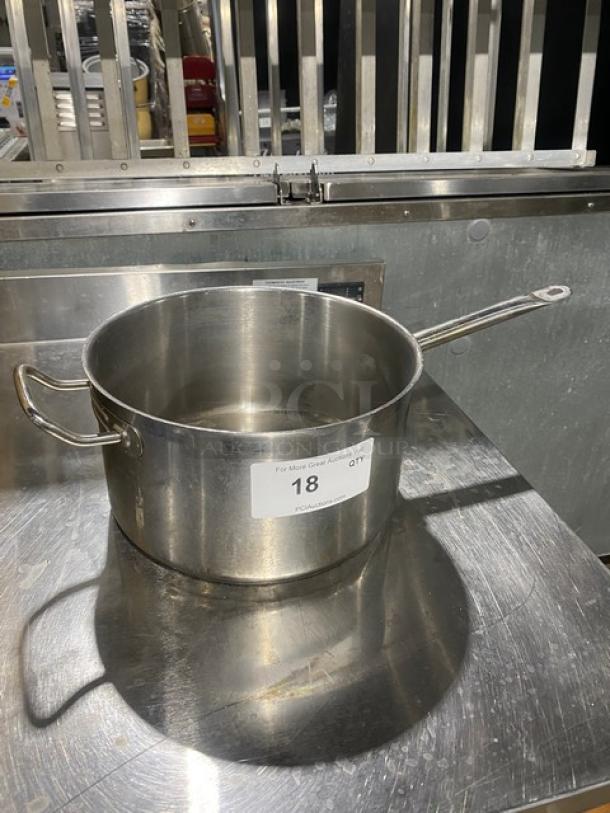Commercial round sauce pot, stainless steel, two handles, excellent condition. Label reads "18 QT." Suitable for heavy-duty use.