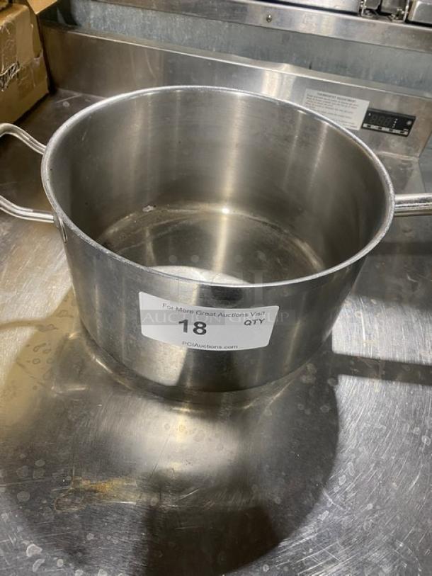 Commercial round sauce pot, stainless steel, with double handles. Marked with auction label "18 QTY." Appears in used condition.
