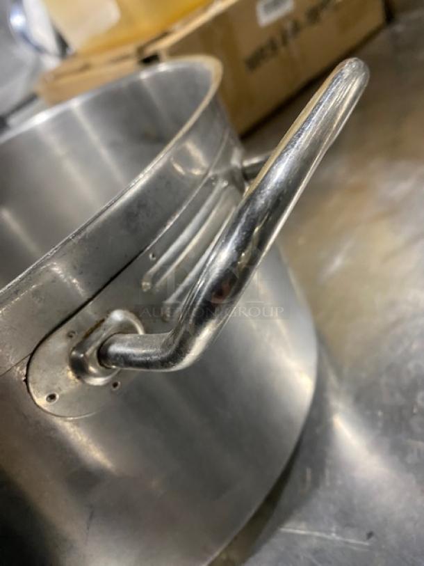 Stainless steel commercial round sauce pot with sturdy handle, minor wear. Ideal for professional kitchens.