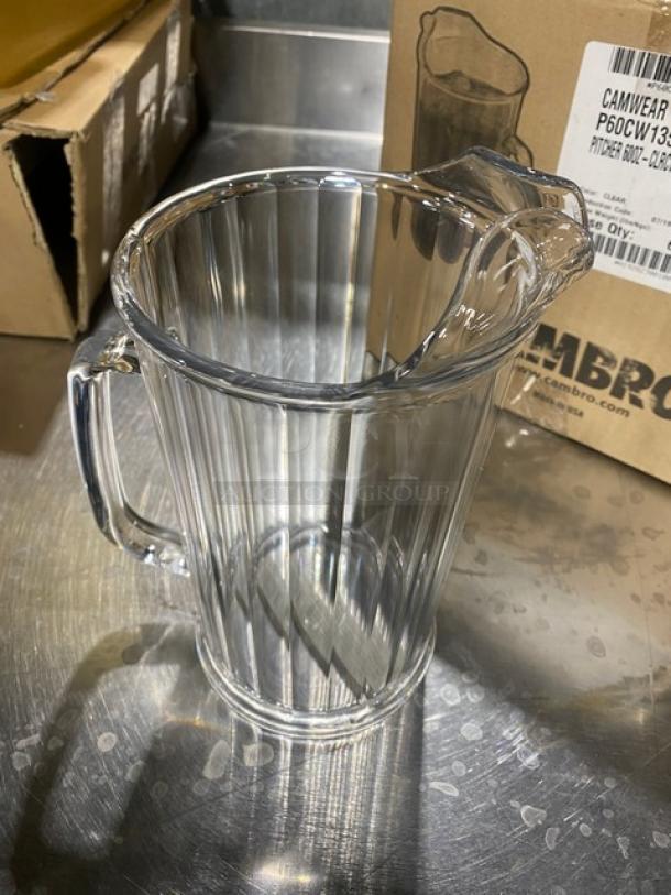 Brand new Cambro Camwear Series 60 oz. clear beverage pitcher, model P60CW135, on a metal surface.