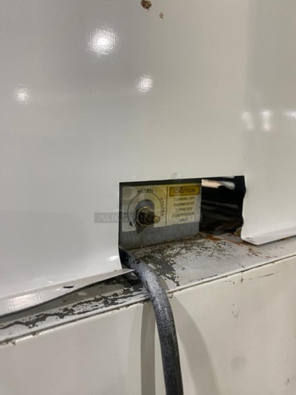 Leer Commercial Ice Merchandiser Freezer, Model 301UC25MG, with visible temperature control knob and caution label.