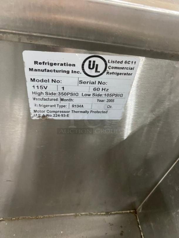 Leader 3-door refrigerated prep table, stainless steel, poly-coated racks, 115V, year 2005, on casters, UL listed.