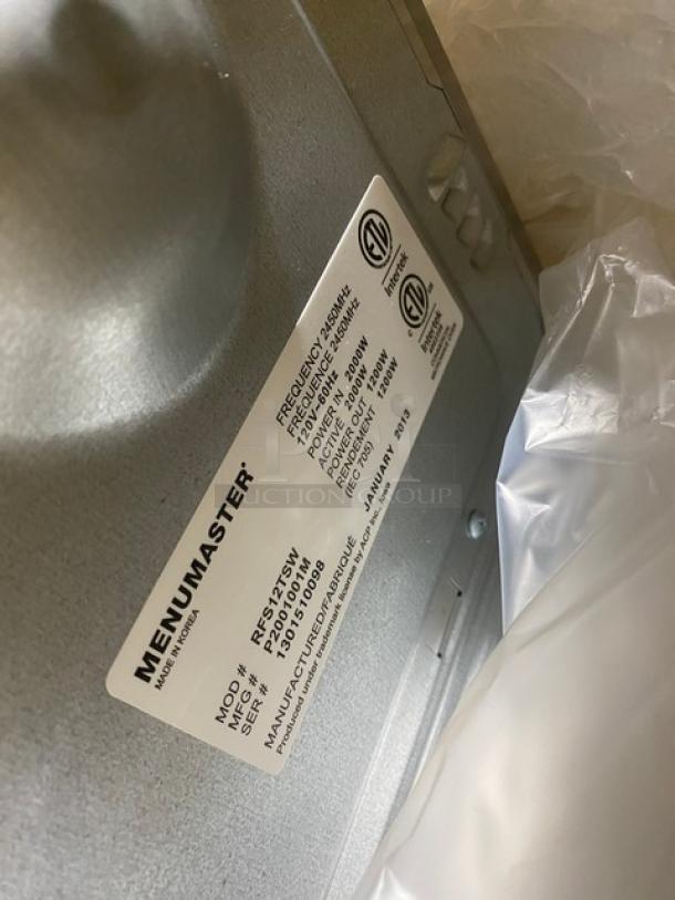 Menumaster RFS12TSW microwave oven, stainless steel, digital controls, new condition, model and serial number tag shown.