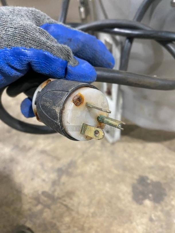 Close-up of electrical plug for Hobart 6460C potato peeler. Plug shows minor rust. Peeler is commercial-grade, heavy-duty.