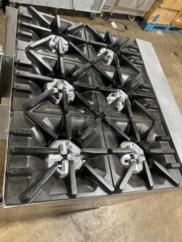 U.S. Range 6-burner stainless steel stove with enclosed cabinet base, natural gas, on casters, commercial grade.