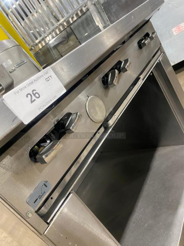 U.S. Range commercial 6-burner stainless steel natural gas range with enclosed dry cabinet base on casters. Visible control knobs.