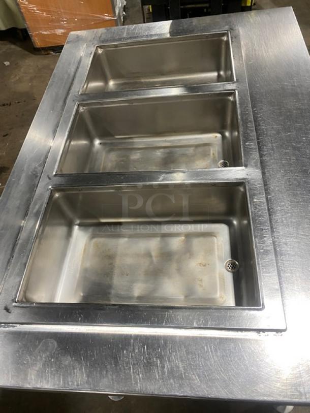 Wells MOD300TDM stainless steel 3-well hot food/steam table with single undershelf, electric powered, 208/240V, on legs.