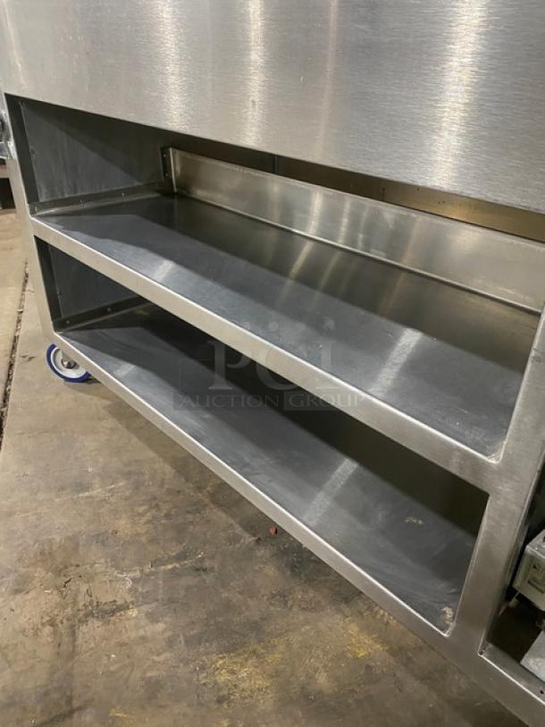 Precision stainless steel refrigerated cold food/salad bar, model SST2024RTNYC, with double overhead shelf and casters.