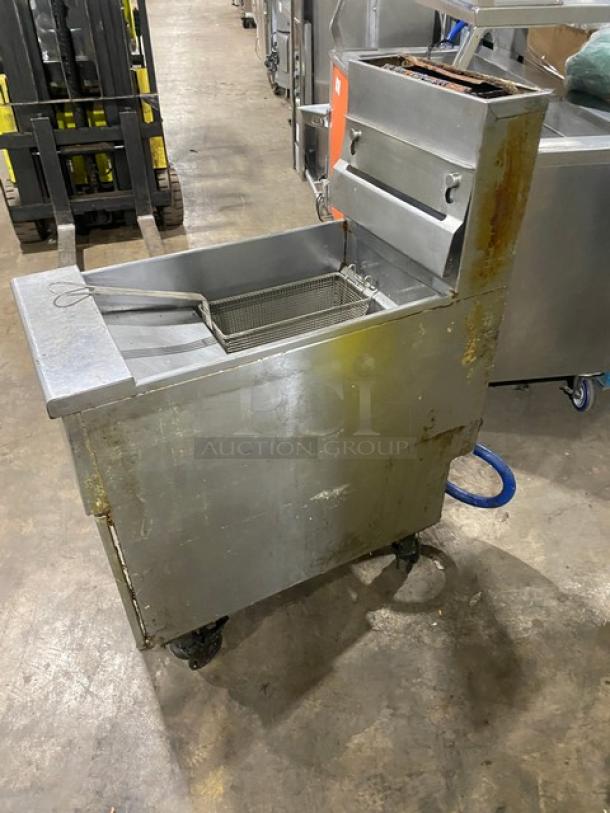 Pitco VF35 stainless steel natural gas fryer, 35 lb capacity, with basket, backsplash, and gas hose. On casters, used condition.