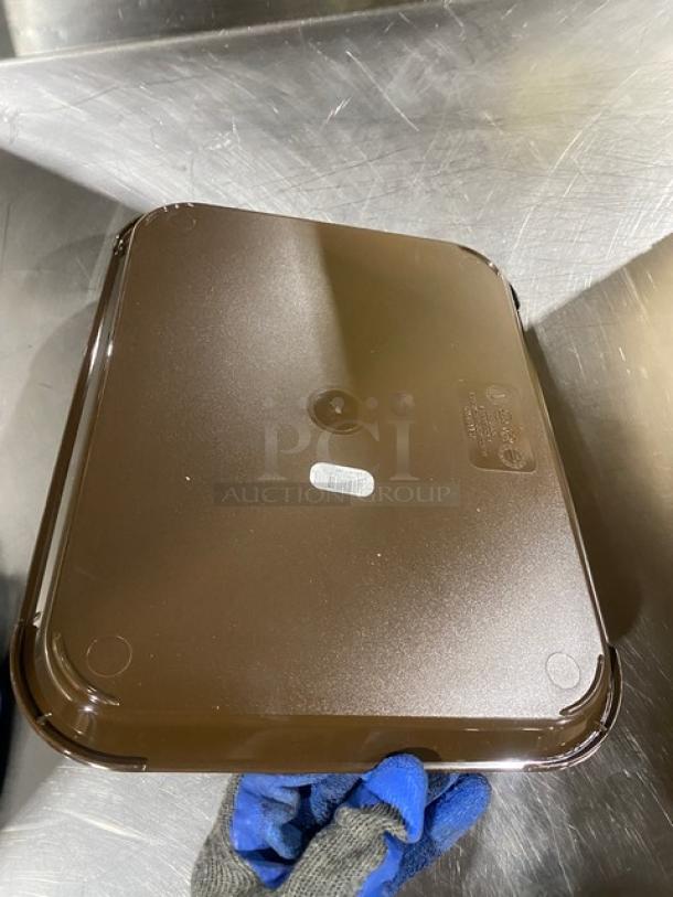 Cambro 10"x14" rectangular brown serving tray, model 1014FF167, new condition, textured surface, brand marking visible.