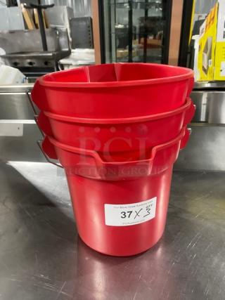 Commercial red round mop bucket, stack of three, with pale-style handles. Auction label shows "37 X 3." In good condition.