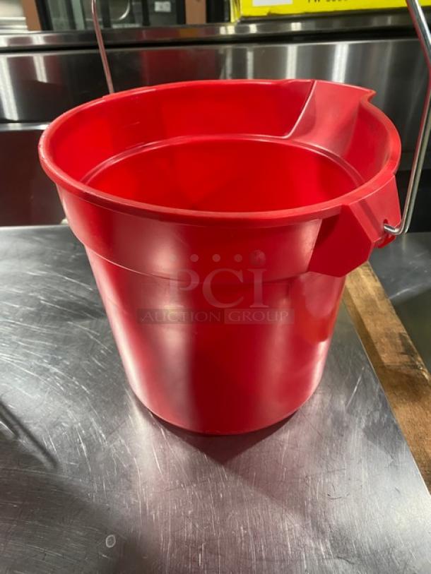 Commercial red round mop bucket, features pale style handle. Durable plastic construction, good condition, utility use.