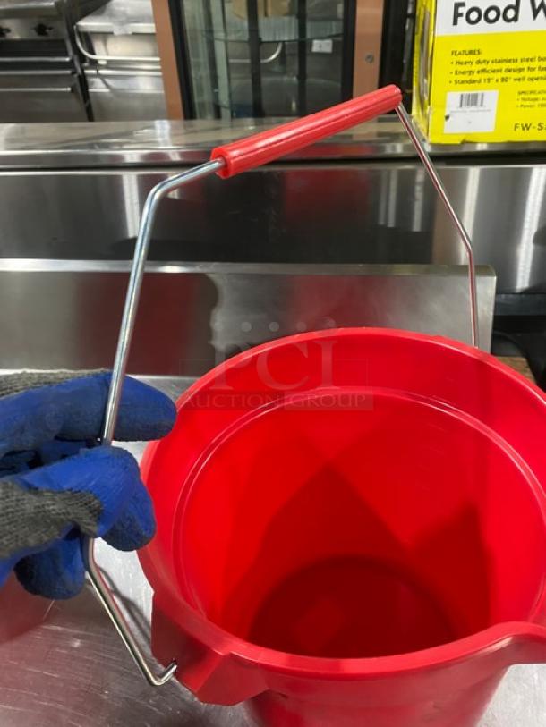 Commercial red round mop bucket with metal handle, excellent condition. Features pale style grip for utility use.
