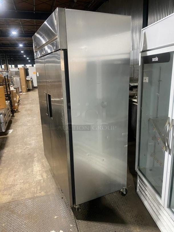 True TM52 commercial stainless steel 2-door refrigerator with poly-coated wire rack, SN: 1-3107073, on casters.