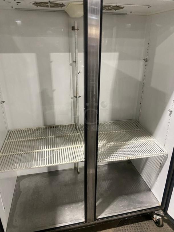 True TM52 stainless steel 2-door reach-in refrigerator with poly-coated wire racks, on casters. Model: TM52, SN: 1-3107073.