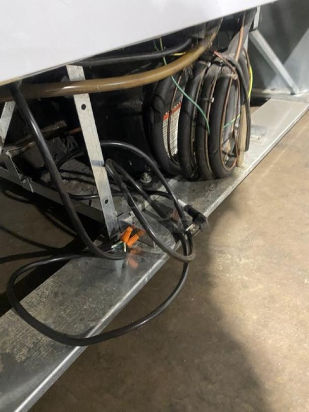 Beverage-Air MT49 commercial refrigerator compressor area with wiring and coils, showing components and condition.