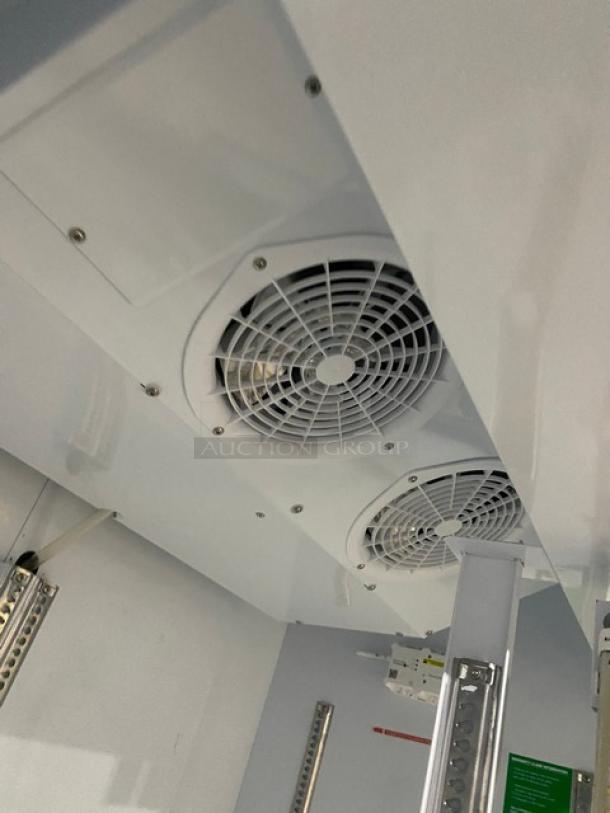 Turbo Air TGM-47SDW white commercial refrigerator interior, featuring dual fans and poly-coated wire racks. Energy Star Certified.