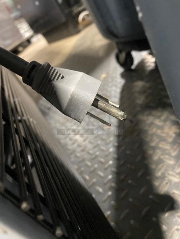 Close-up of a power plug for a Turbo Air TGM-47SDW commercial refrigerator, showing cord and prongs.