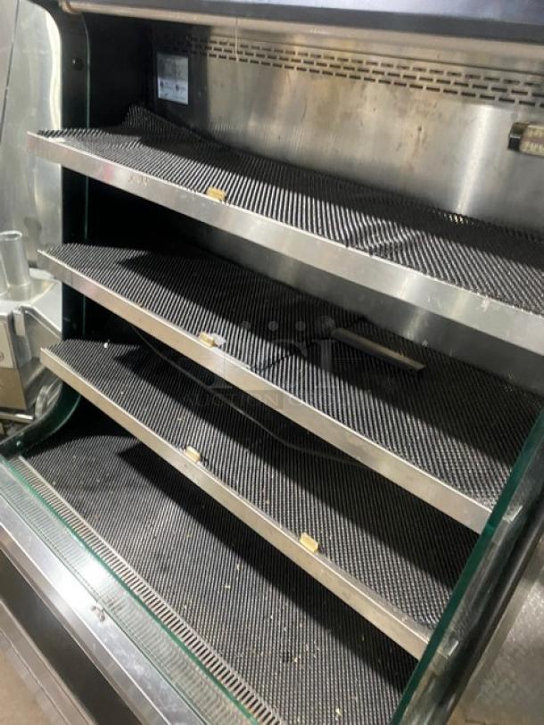 Turbo Air TOM-40M(B) refrigerated merchandiser, black stainless steel, multi-tier shelves, model label visible, 120V, used condition.