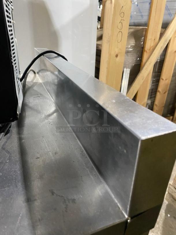 Delfield Enodis Series stainless steel worktop refrigerator, model 402, with upturned backsplash and casters, 115V, SN: 0603036102129-T.