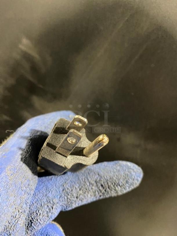 Asbury MIM50P Ice Maker plug; blue-gloved hand holding it. 115V, Energy Star certified. Model SN: 00550820205.