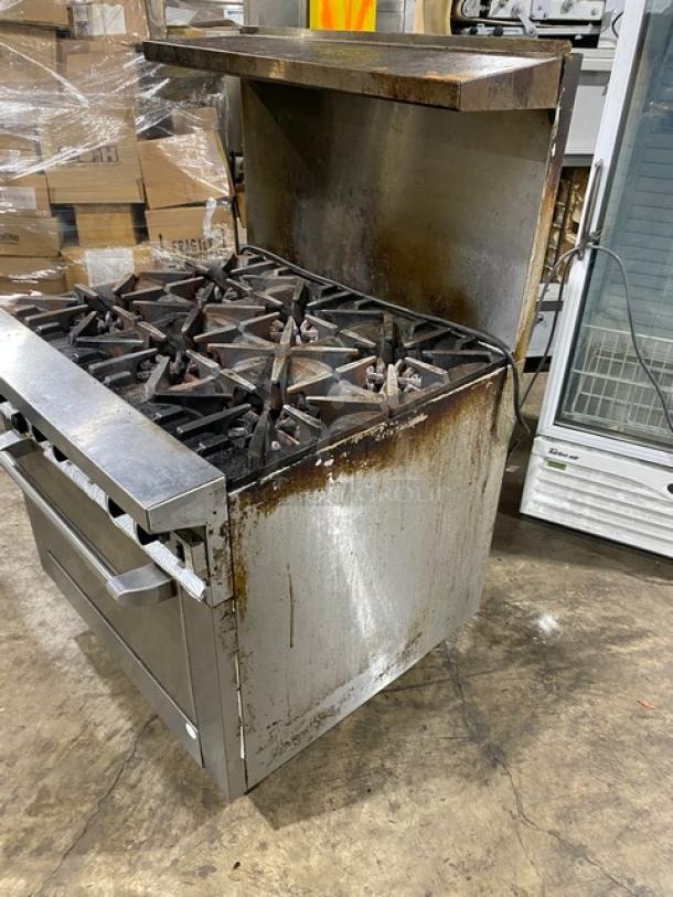 Garland Commercial Stainless Steel Gas 6-Burner Range/Oven Combo with backsplash, overhead salamander shelf, and casters. Used condition.