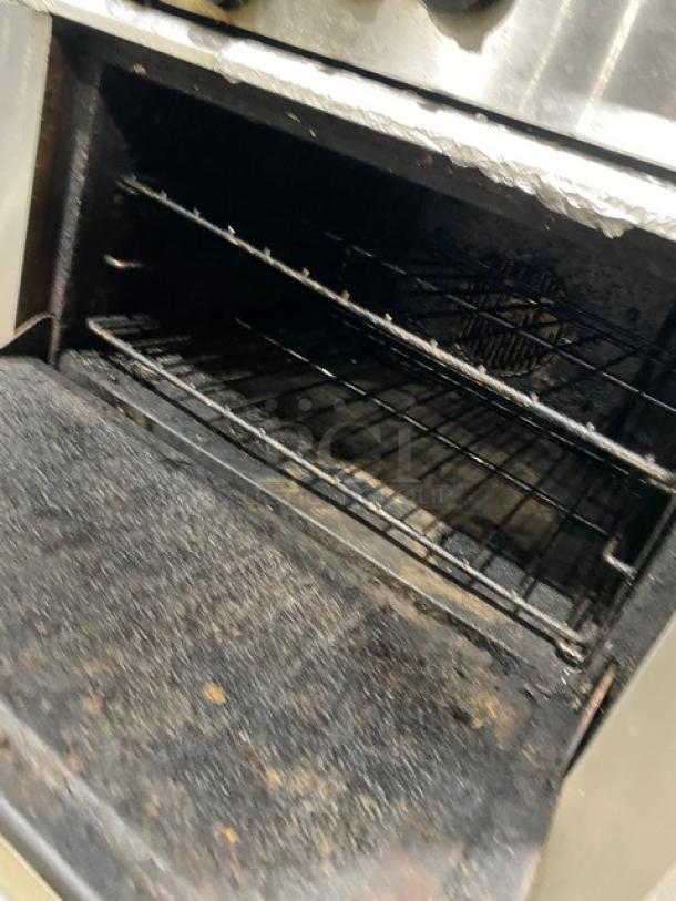 Garland stainless steel gas 6-burner range/oven combo with back splash, overhead salamander shelf, and wired oven rack.