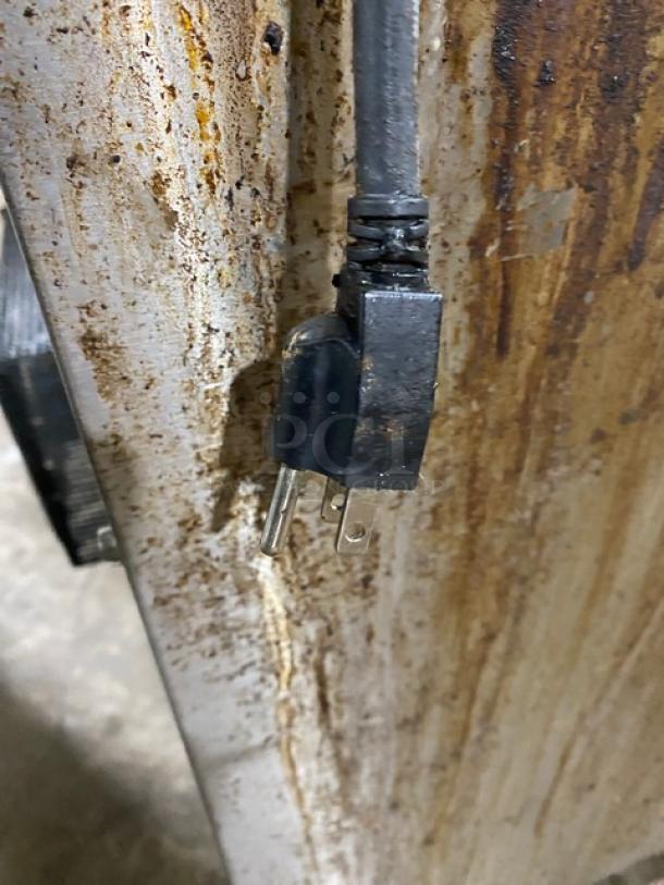 Garland commercial gas range/oven; stainless steel with 6 burners. Includes backsplash, overhead salamander shelf, and casters.