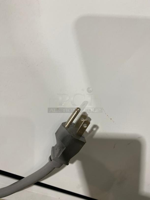 Turbo Air commercial glass swing door ice merchandiser freezer, model TGIM-23W-N, includes poly-coated wired rack.