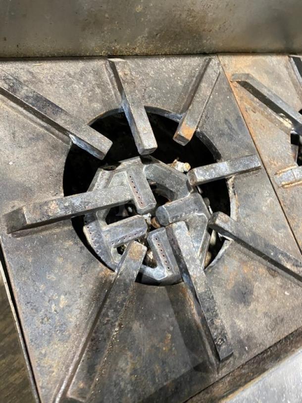 Jade Range commercial stainless steel 8-burner cooktop in used condition, showing detailed burner grates.