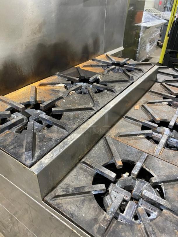 Jade Range commercial 8-burner stove, stainless steel, natural gas, with chef base, backsplash, flue riser, on legs. Used condition.