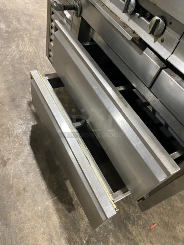 Jade Range stainless steel 8-burner gas range with 2-drawer chef base, backsplash, double back guard, and flue riser.