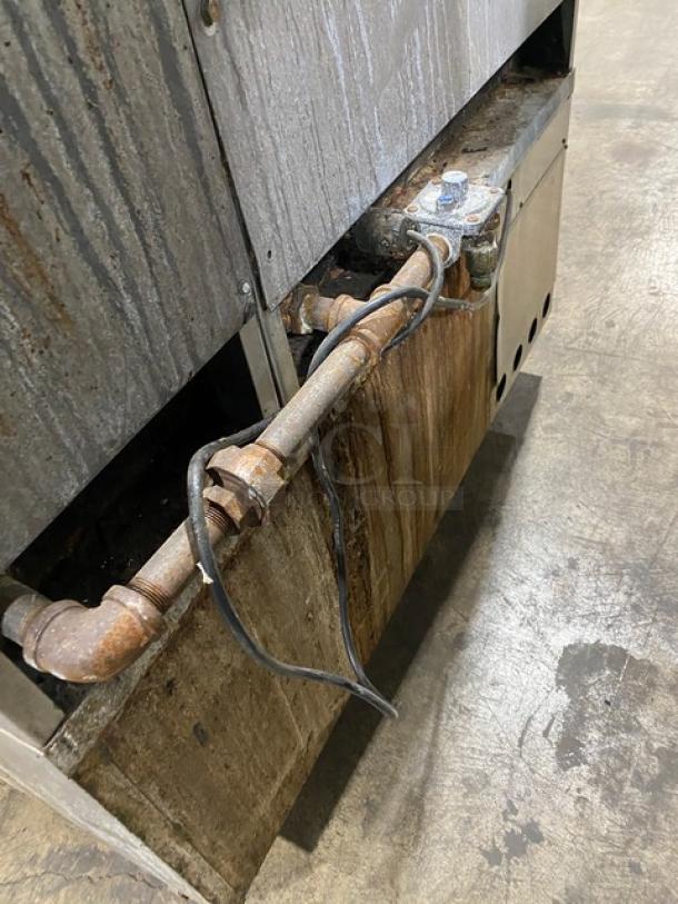 Jade Range commercial stainless steel 8-burner range with 2-drawer chef base, back splash, and flue riser. Visible wear and rust.