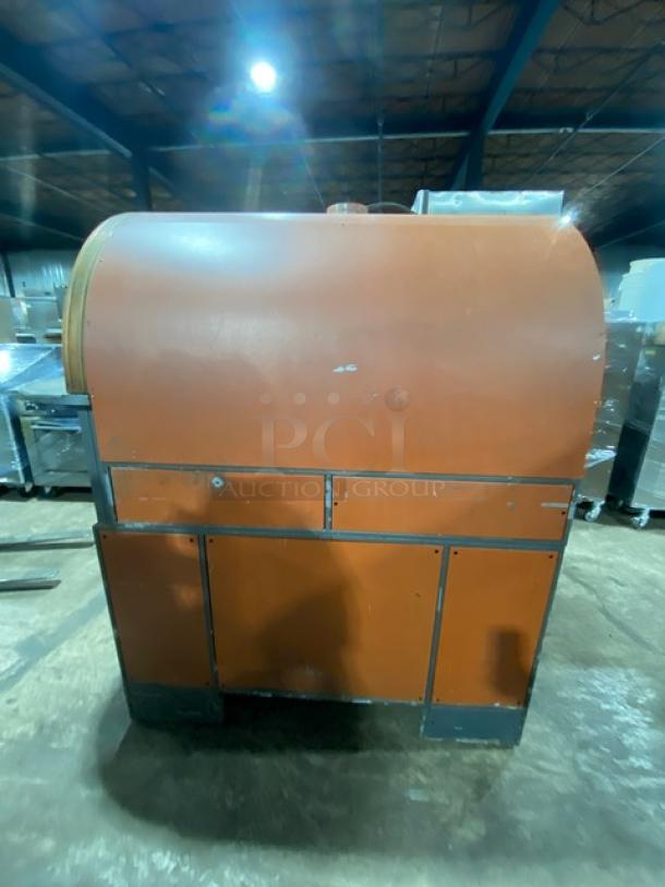 Izzo Forni commercial electric Napoletano pizza oven with pizza paddles. Used condition, orange finish, warehouse background.