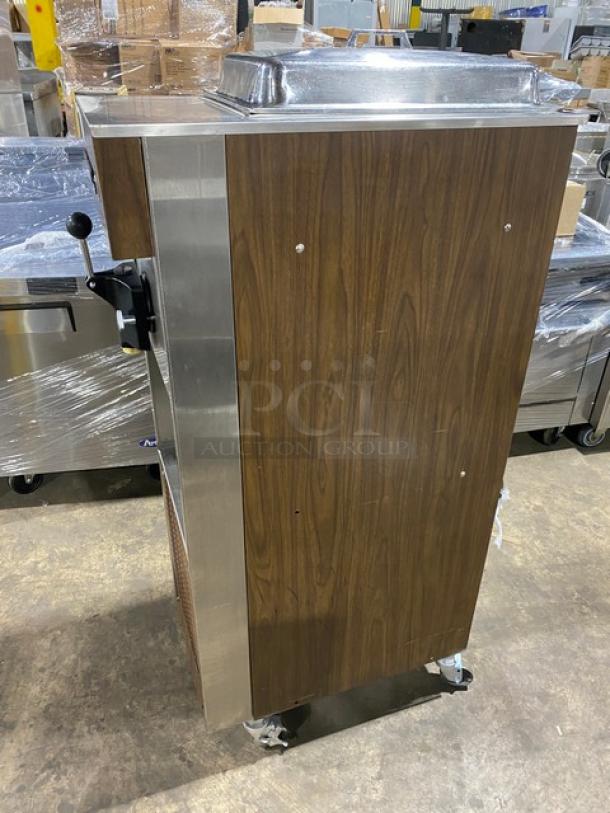 Electro Freeze single flavor soft serve machine, stainless steel with wood-style finish, on casters, electric powered.