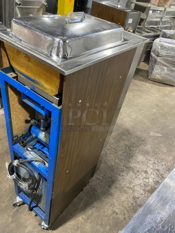 Electro Freeze stainless steel single flavor soft serve machine, wooden-style exterior, on casters, used condition.